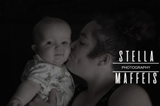 Mother kissing her babys cheek.
