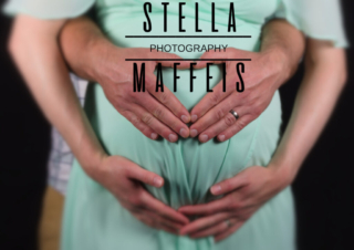 Zoomed in image of a husband and wife holding her pregnant belly.